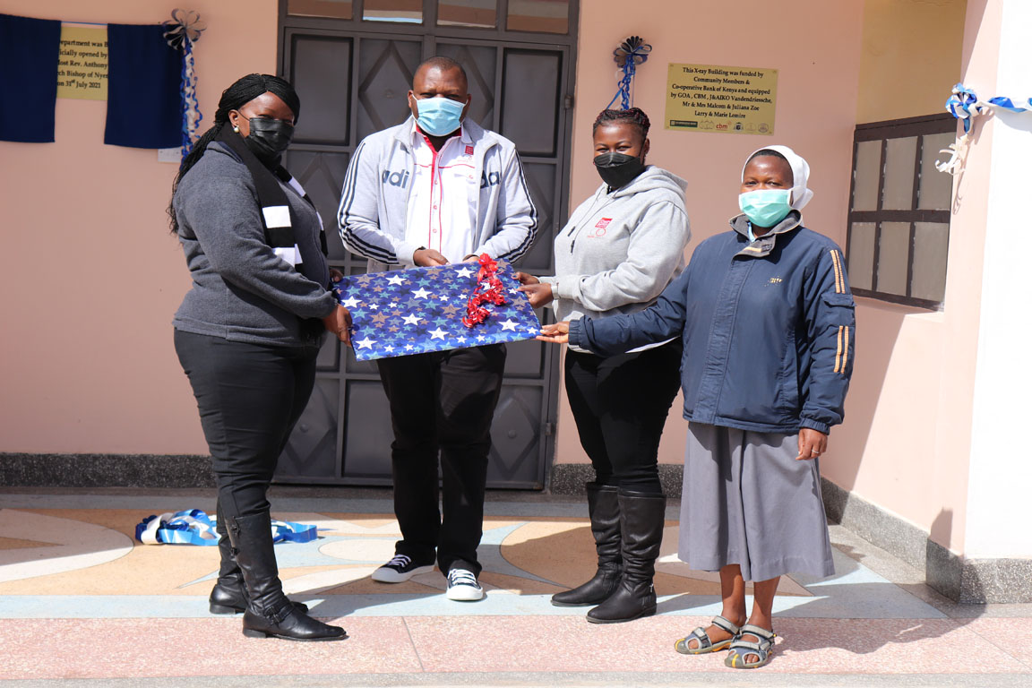 Cecilia Mutava receiving a gift from Naromoru Disabled Children’s Home