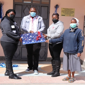 Cecilia Mutava receiving a gift from Naromoru Disabled Children’s Home